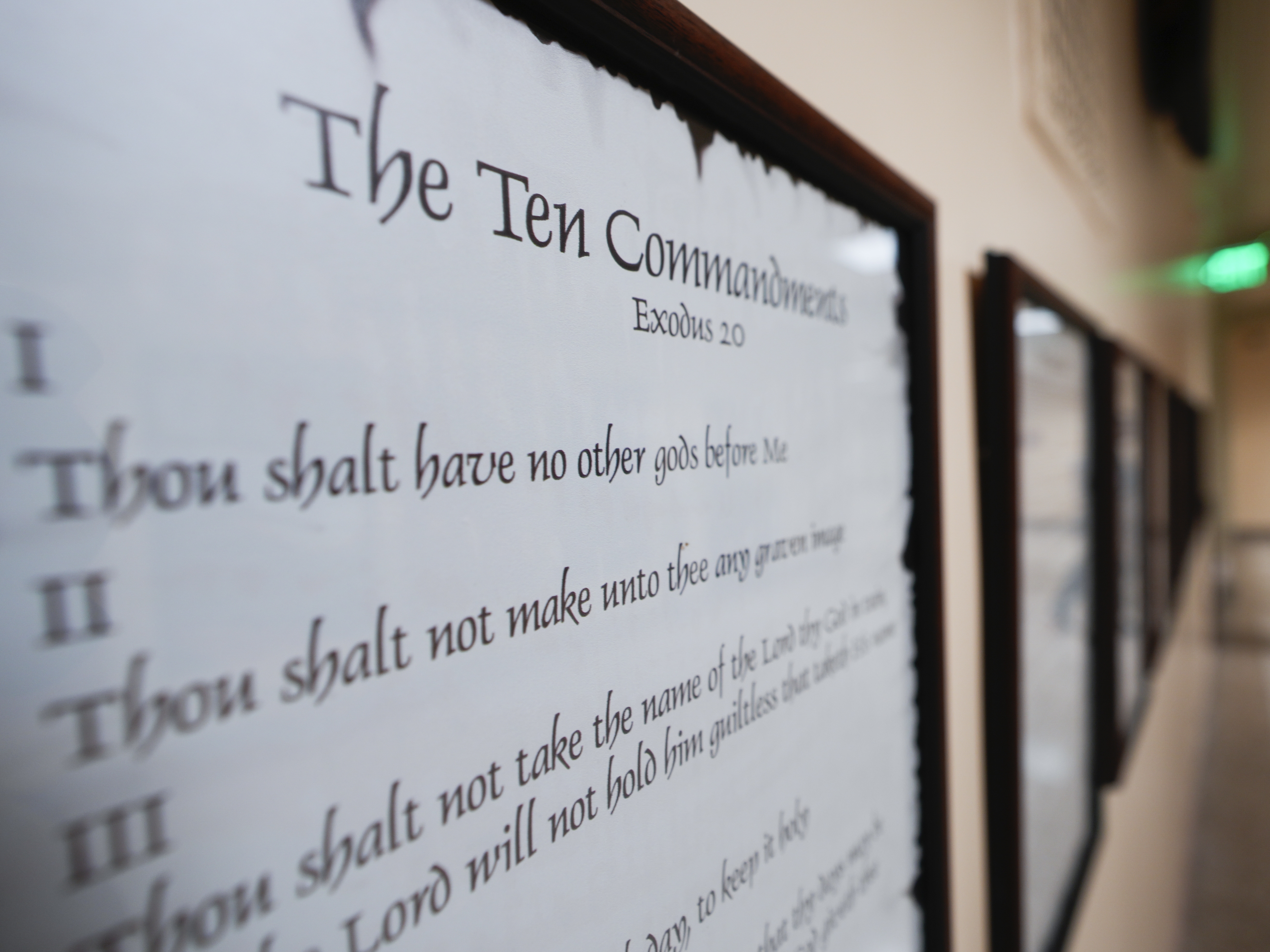 caption: A copy of the Ten Commandments is posted along with other historical documents in a hallway at the Georgia Capitol in Atlanta on June 20, 2024. On Friday, a panel of federal appellate judges ruled that a Louisiana law requiring the Ten Commandments to be posted in the state's public school classrooms is unconstitutional.