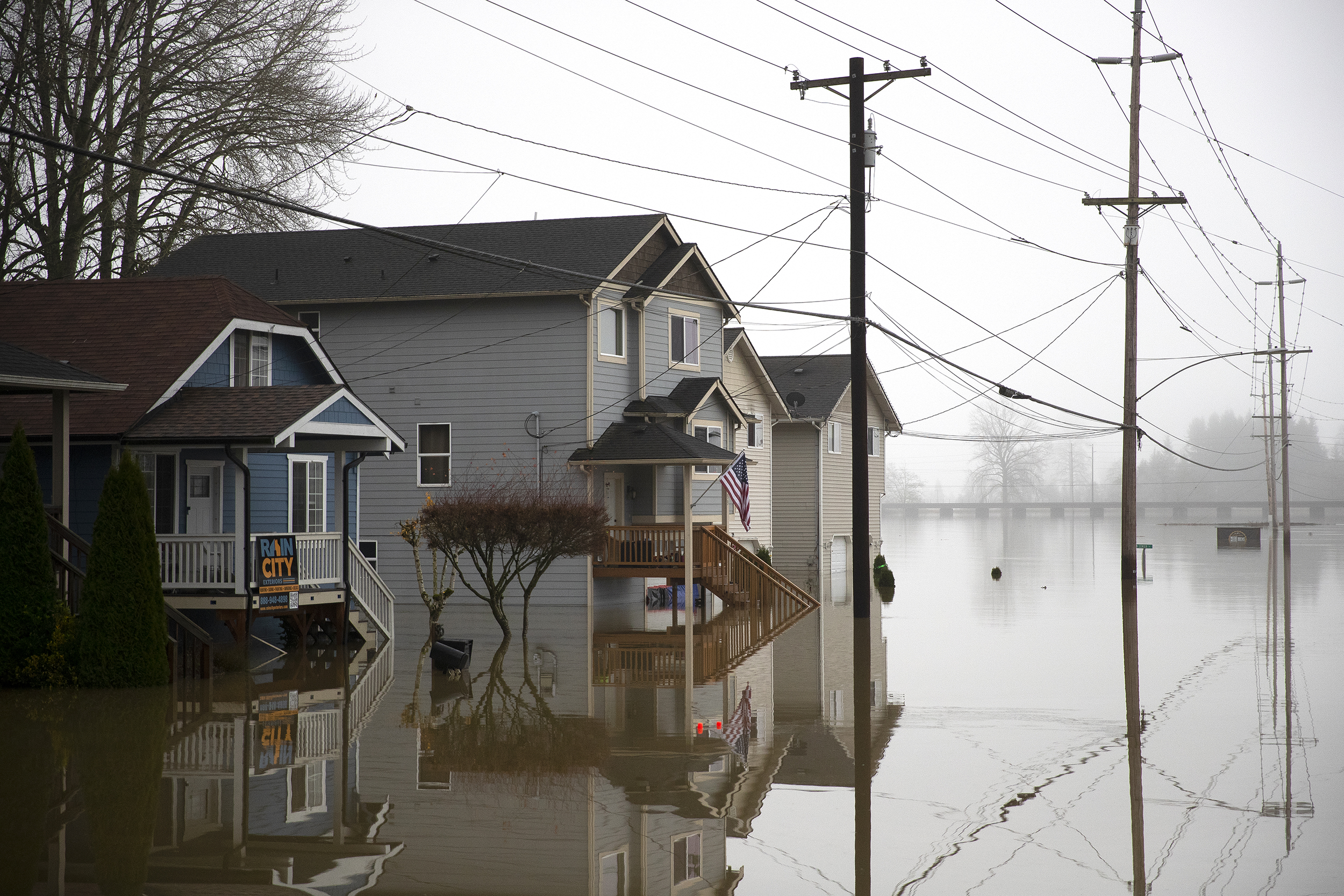 caption: An office door at Gagnon Welding is shown partially underwater as flooding continues on Friday, December 12, 2025, in Snohomish. 