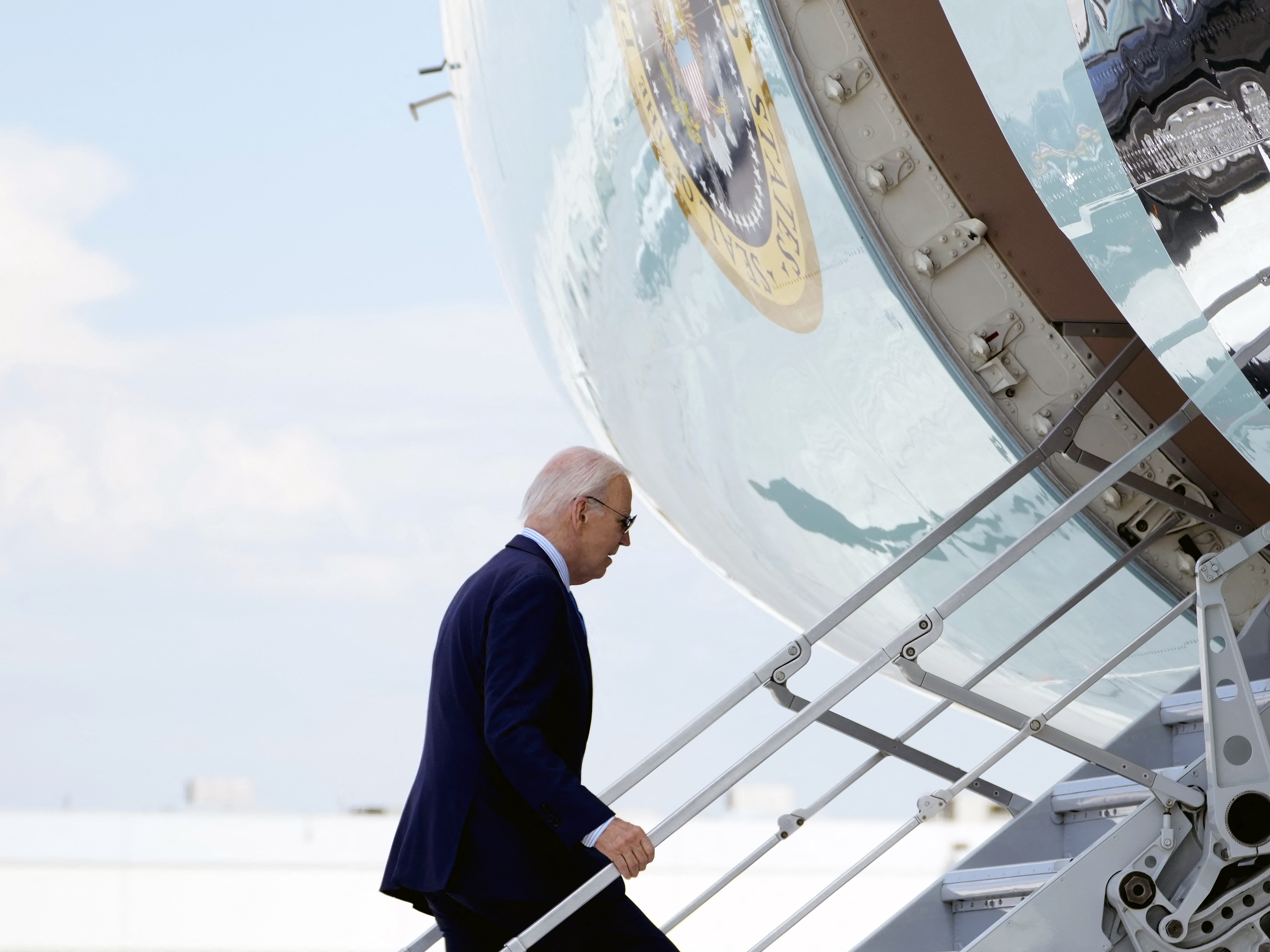 caption: President Biden boards Air Force One as he departs Harry Reid International Airport in Las Vegas, Nevada, on July 17, 2024, en route to Delaware, after testing positive for COVID.