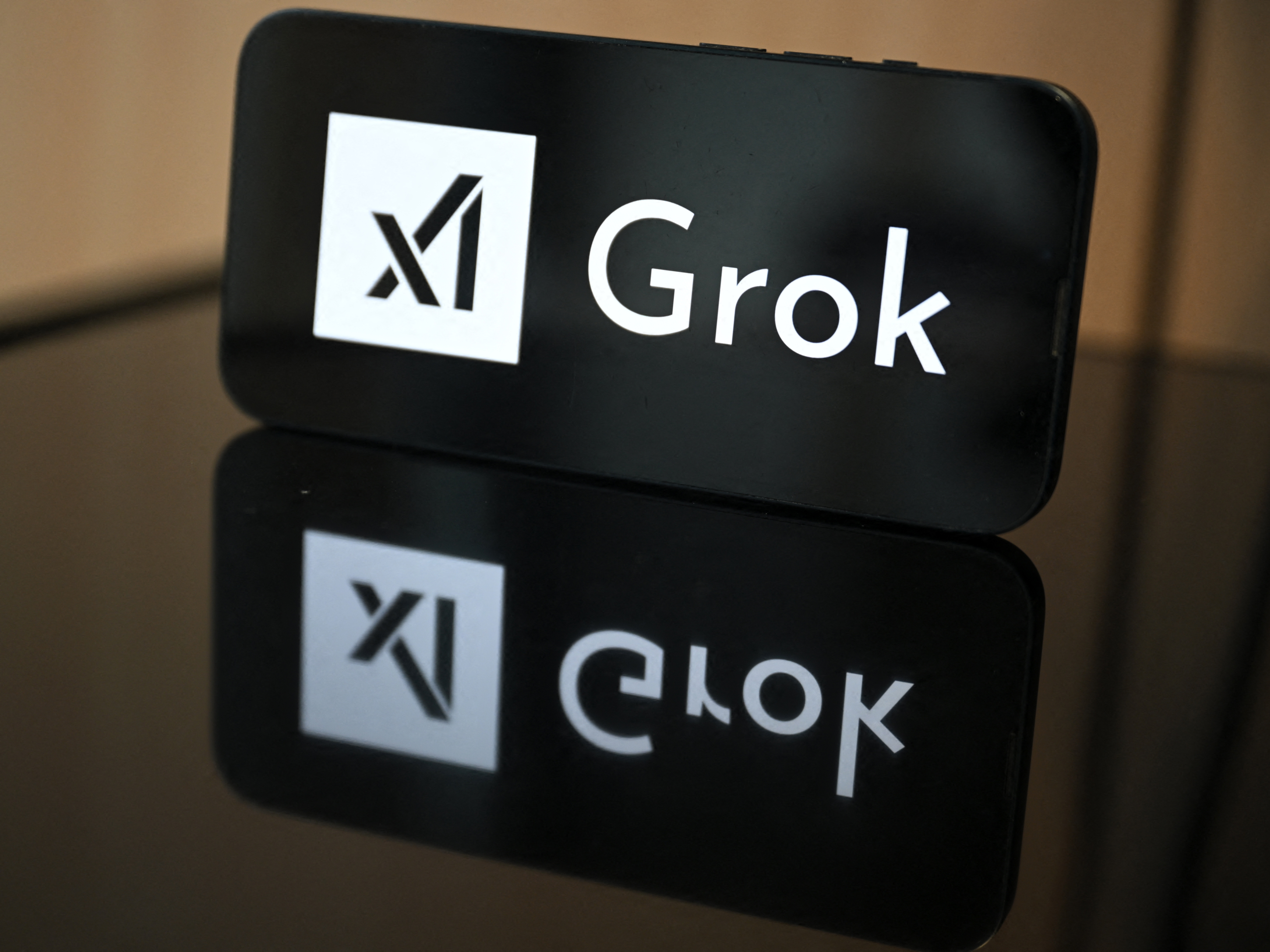 caption: Elon Musk's artificial intelligence company, xAI, which makes the Grok chatbot, is being sued by teenagers who say the company's AI models were used to create nonconsensual nudes of them.