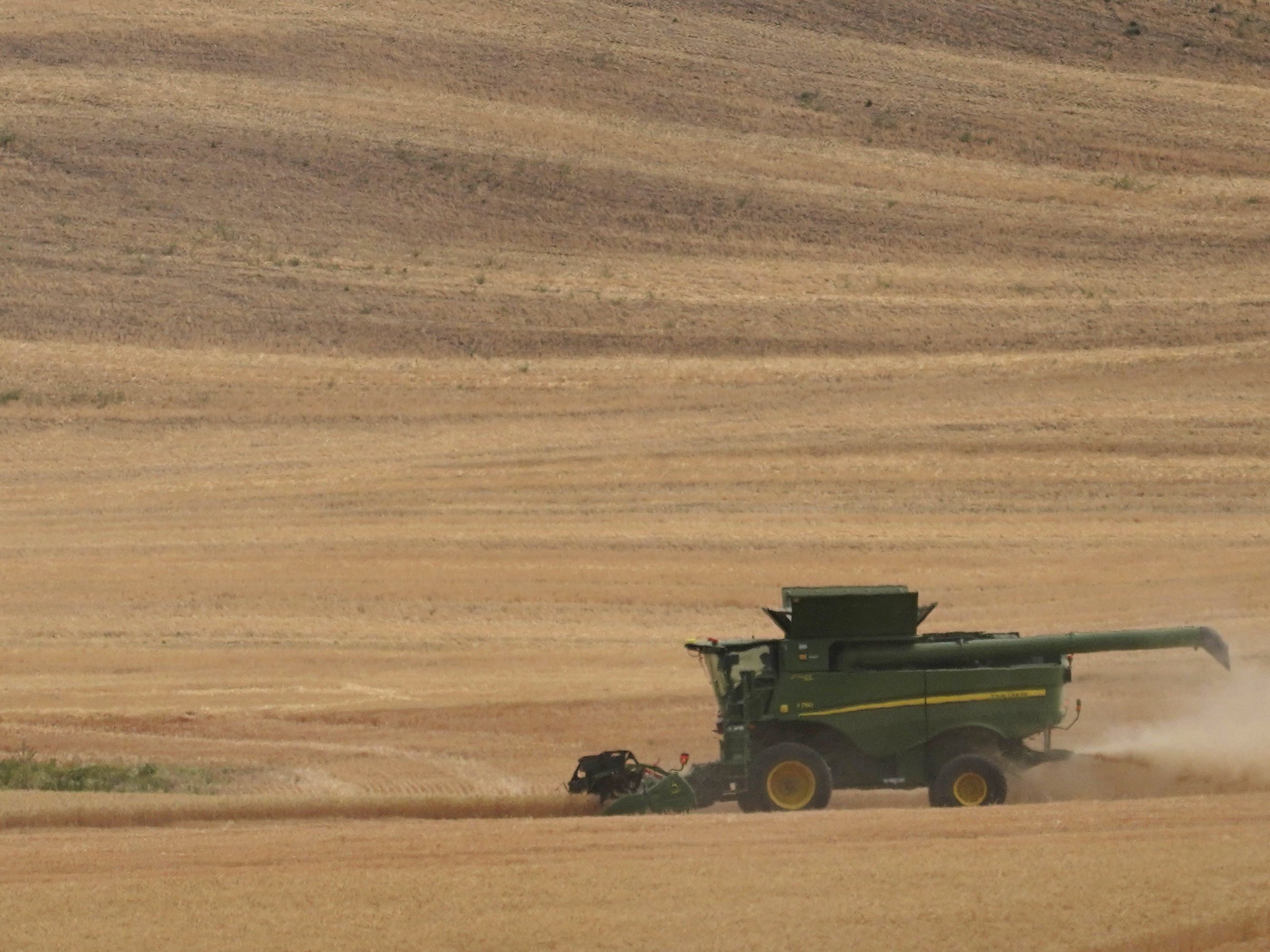 caption: A combine harvests wheat, near Pullman, Wash. Preventing food insecurity globally amid skyrocketing prices driven by the war in Ukraine will be the main topic at the IMF and World Bank Spring Meetings.