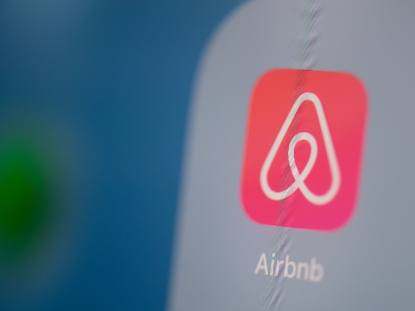 caption: Airbnb is listing shares of its initial public offering Thursday, capping a tumultuous year for the short-term rental company.