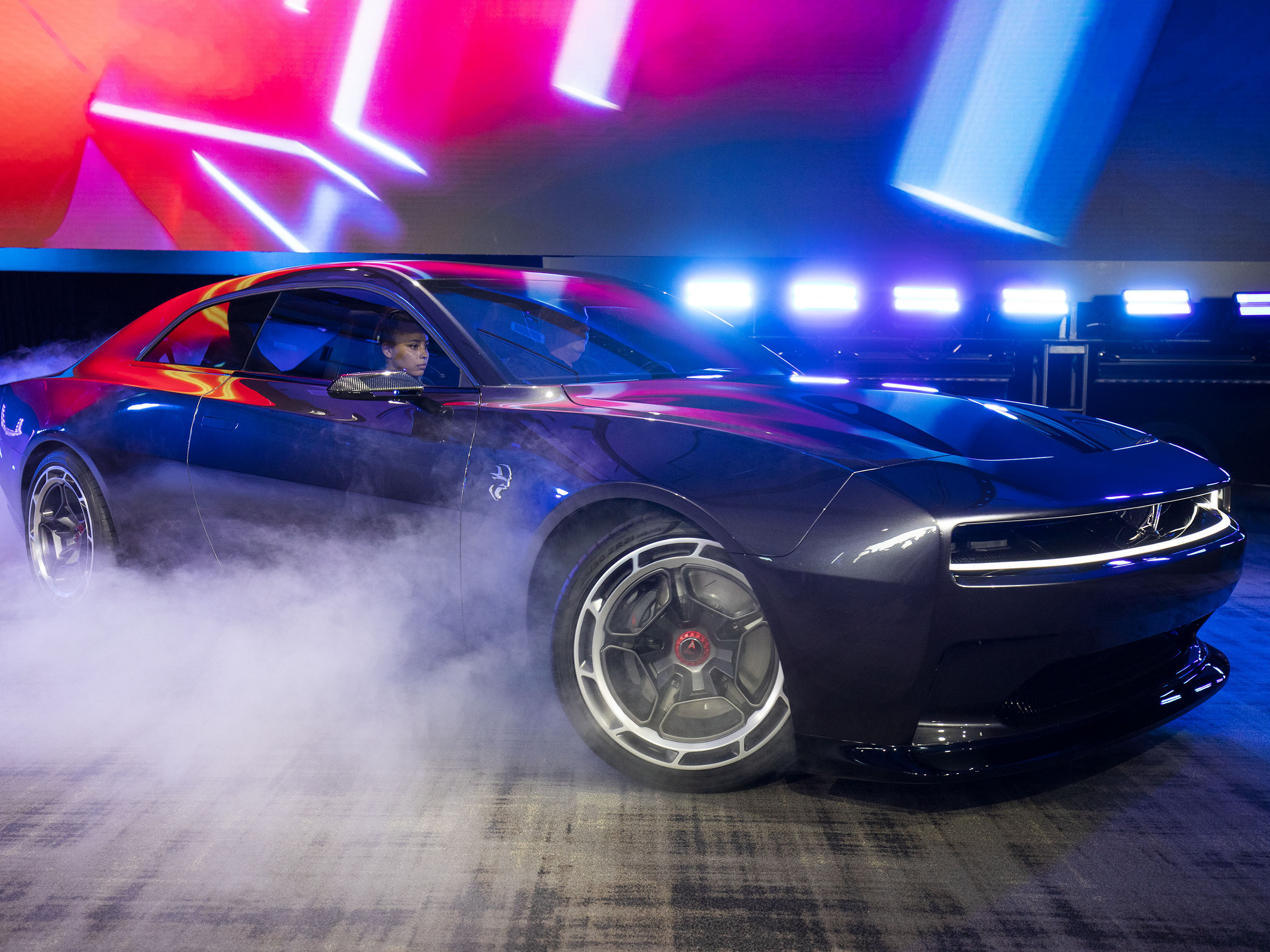 caption: The Dodge Charger Daytona SRT Concept all-electric muscle car is shown at its world reveal during Dodge's Speed Week at M1 Concourse on Aug. 17 in Michigan. As the popularity of EVs explodes, U.S. battery production is rapidly growing.