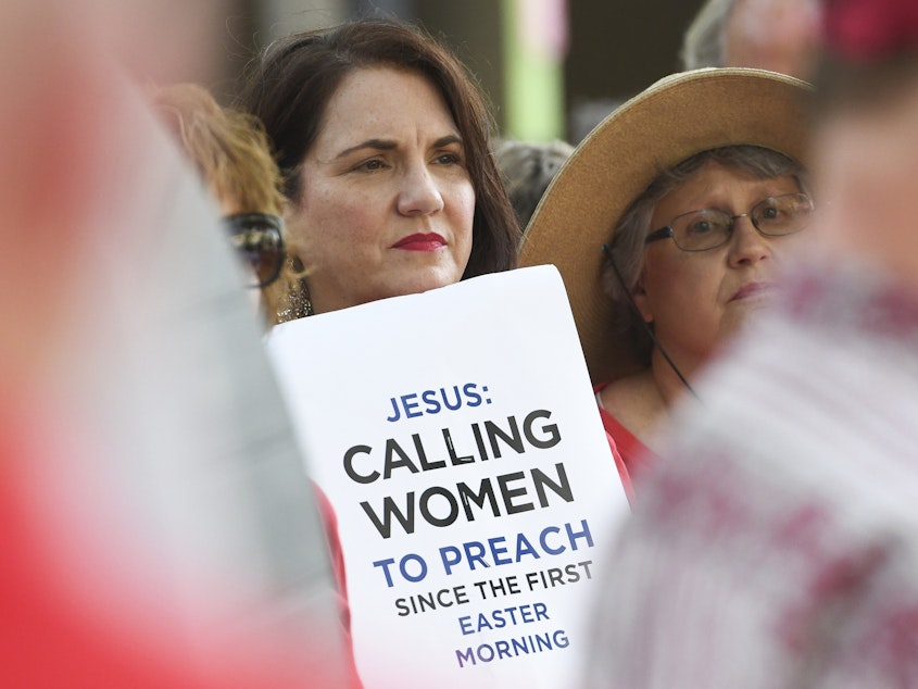 caption: Janene Cates Putman of Athens, Tenn., demonstrates outside the Southern Baptist Convention's annual meeting on Tuesday, during a rally in Birmingham, Ala.