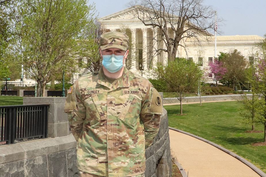 caption: U.S. Army Sgt. Kyle Conley,1st Battalion, 161st Infantry Regiment, Washington National Guard, poses for a photo near the U.S. Capitol grounds in Washington, D.C., April 10, 2021. 