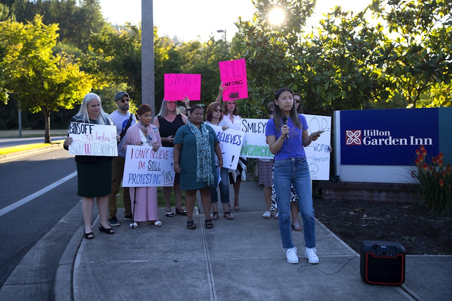 caption: Jean Yu, 17, urges voters to support abortion rights and U.S. Sen. Patty Murray, on Tuesday, August 2, 2022, outside of a Republican primary election night party at the Hilton Garden Inn in Issaquah. 