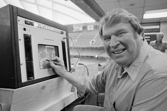 caption: Former Oakland Raiders coach John Madden practices the electronic charting device Telestrator on Jan. 21, 1982, for the Super Bowl broadcast on CBS. Madden, the Hall of Fame coach turned broadcaster, died Tuesday morning, Dec. 28, 2021.