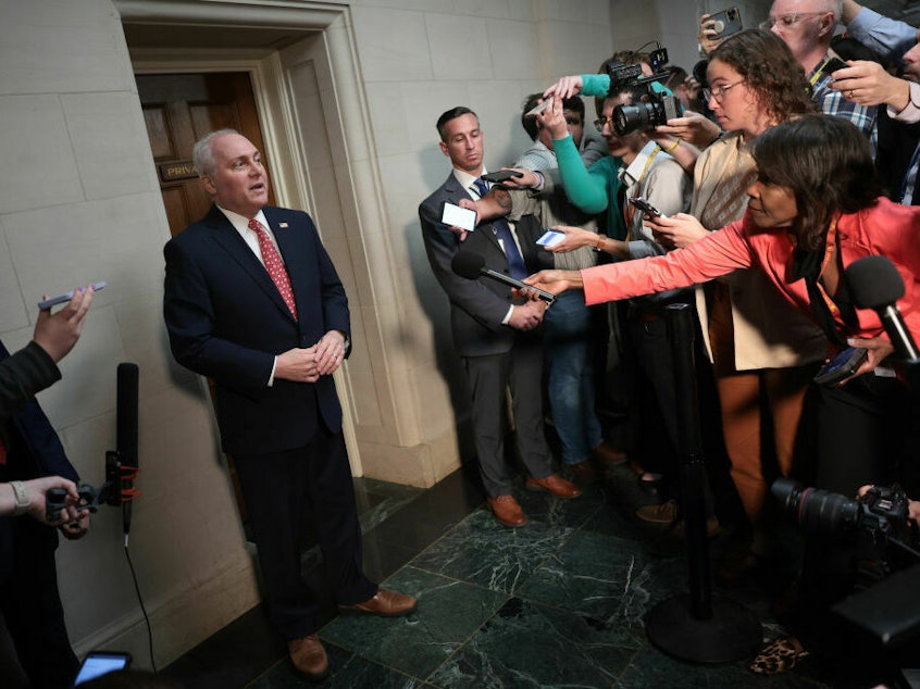 caption: House Majority Leader Steve Scalise, who along with Rep. Jim Jordan is vying for the speakership, talks to the media Tuesday.