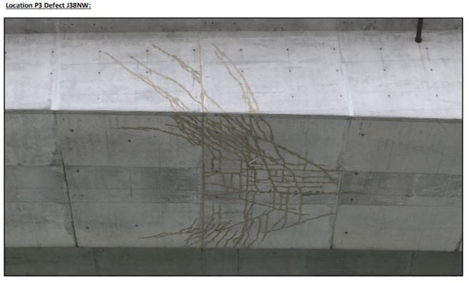 caption: A network of cracks on the underside of the West Seattle Bridge