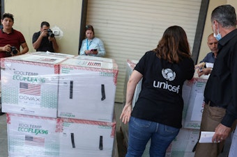 caption: Palestinian Health Ministry staff members in Nablus receive 300,000 doses of COVID vaccines donated by the United States through through the COVAX vaccine-sharing initiative on August 24, 2021.
