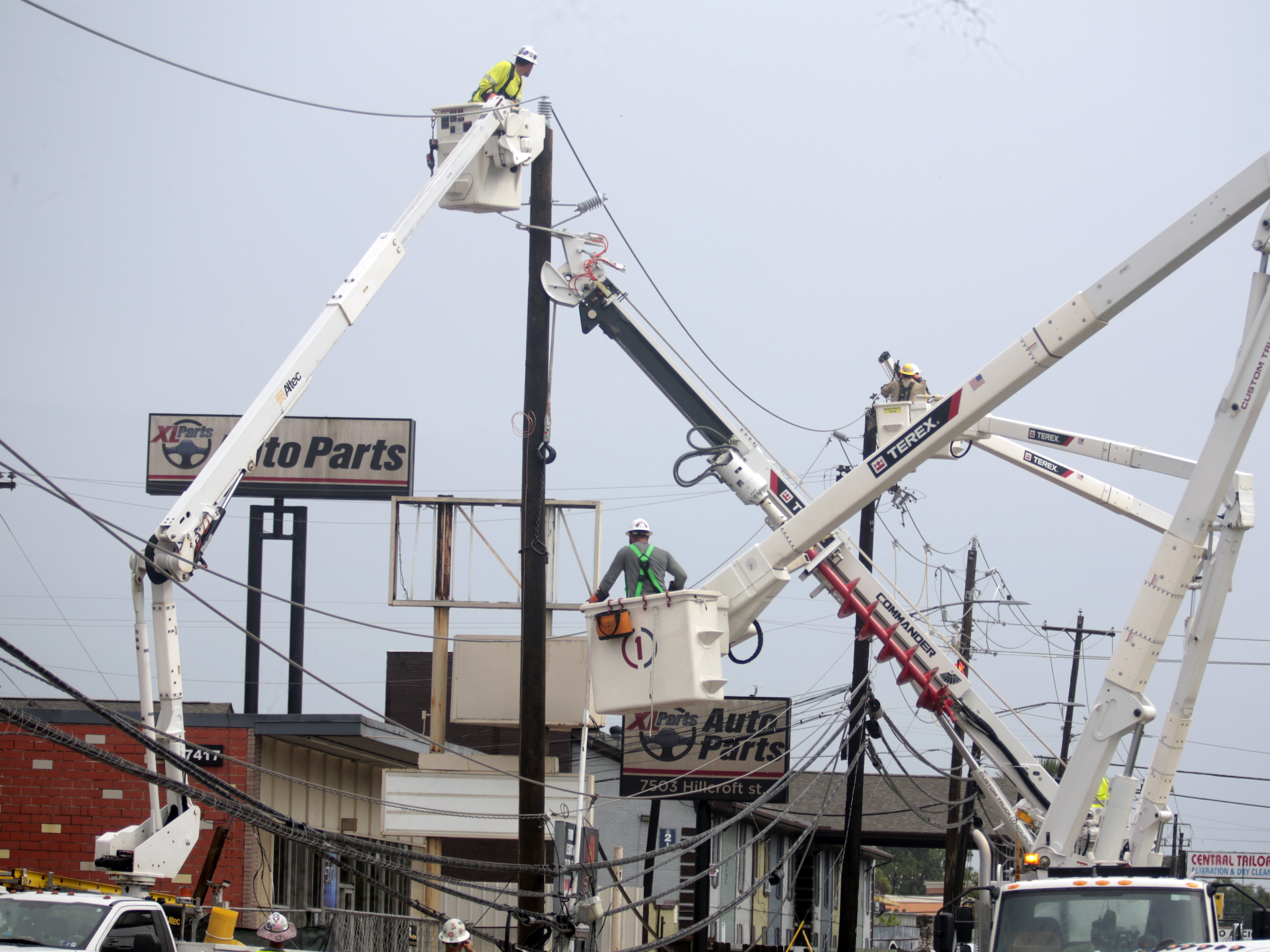 caption: Utility crews work to restore electricity in Houston on Thursday. Prolonged outages following Hurricane Beryl has some fed-up and frustrated residents taking out their anger on repair workers who are trying to restore power.