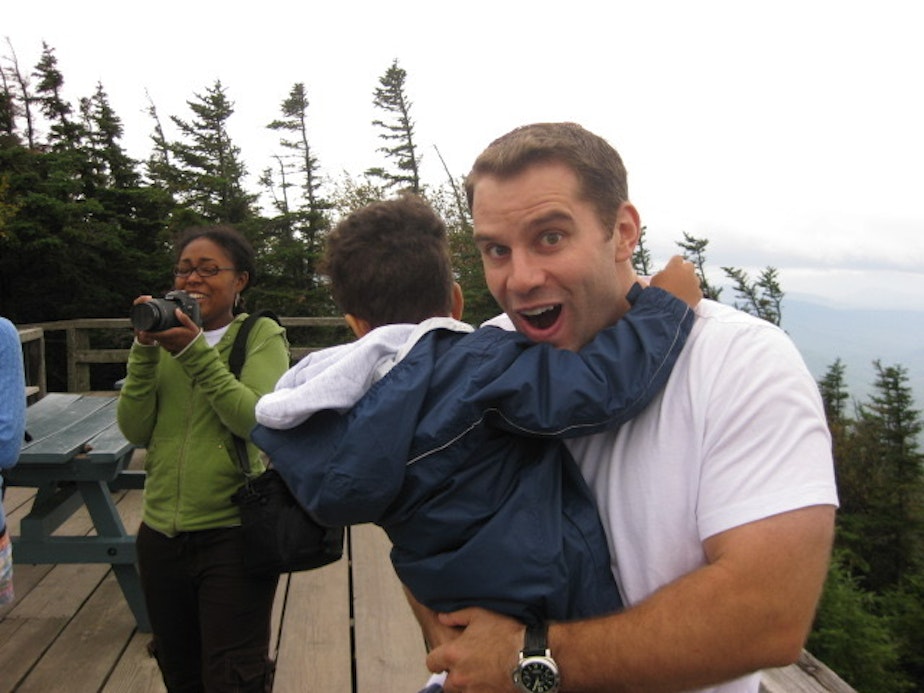 caption: Josh Mulfelder (right) holds Gavin Mulfelder alongside Amelia Gavin (left) on vacation in upstate New York in 2008. 