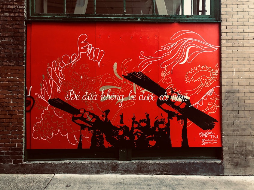 caption: Seattle International District mural by Vietnamese artist Tân Nguyen and Black Seattle artist Moses Sun. The text reads, "chopsticks in a bundle are unbreakable." This mural was part of the inspiration behind Kristin Leong's #AZNxBLM project. Learn more at RockPaperRadio.com. 
