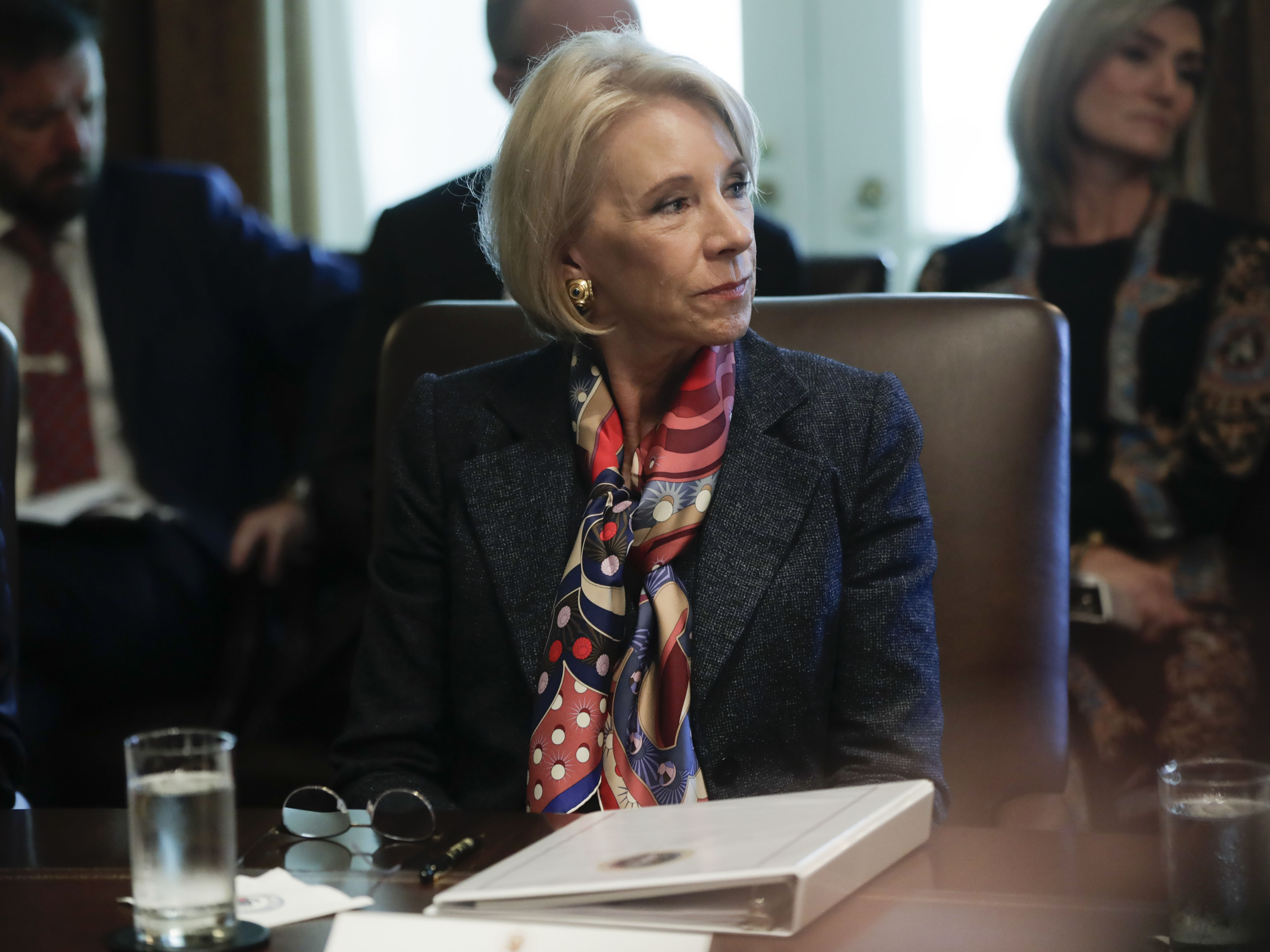 caption: Education Secretary Betsy DeVos attends a Cabinet meeting at the White House on Oct. 21.