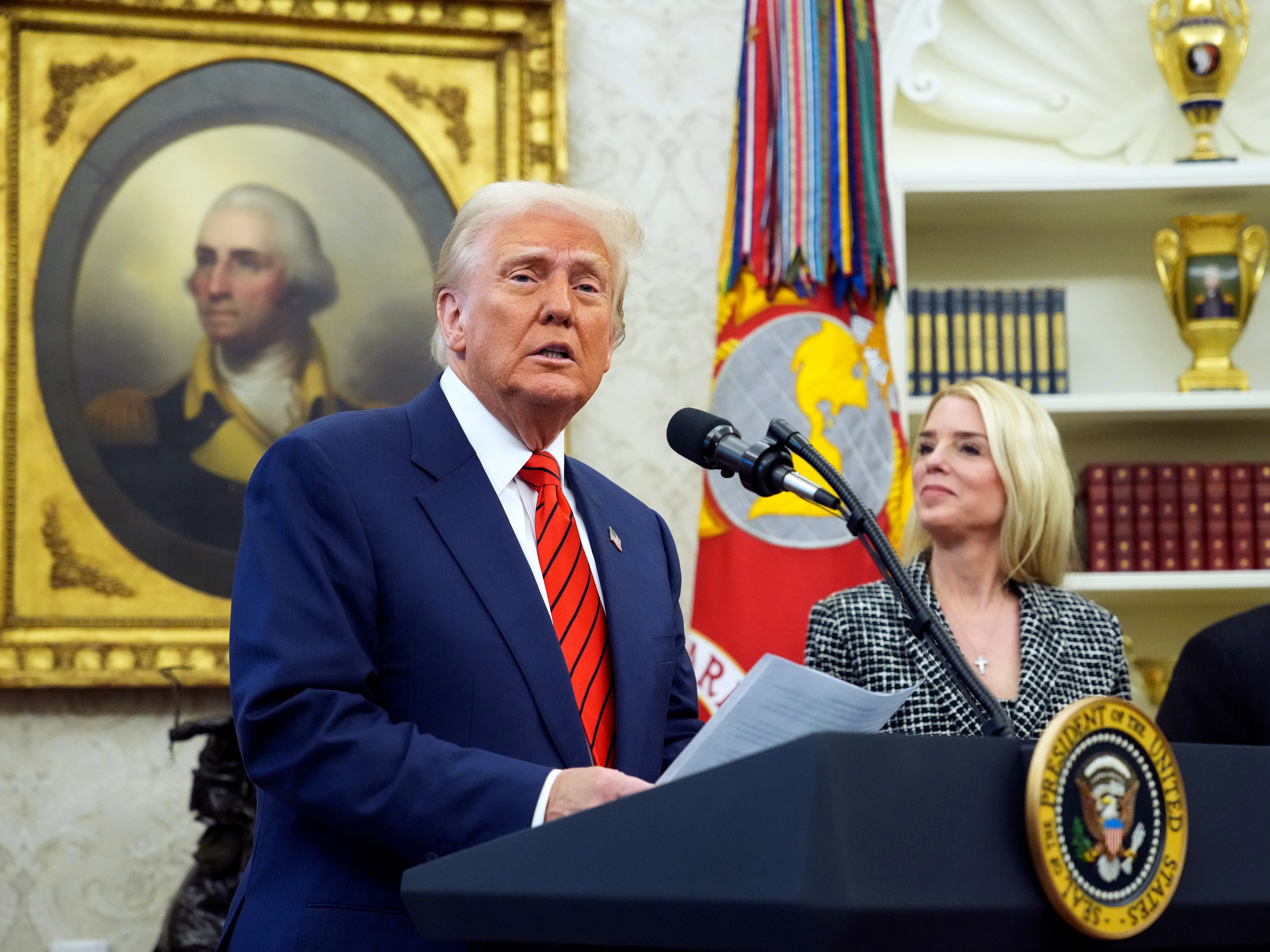 caption: President Trump speaks alongside Attorney General Pam Bondi during her swearing-in ceremony at the White House on Feb. 5.