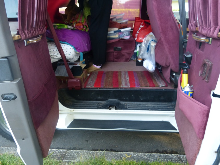 caption: The back of Elizabeth Jay's Dodge Ram minivan doubles as her living room and bedroom.