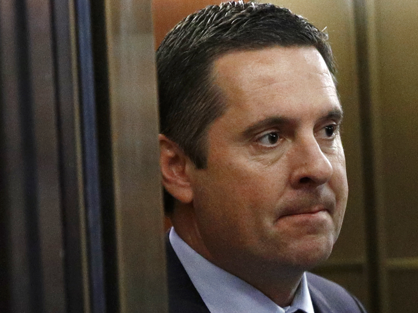 caption: Rep. Devin Nunes, R-Calif., stands in an elevator after departing a secure area of the Capitol on Dec. 3. His appearance in call logs in the Democrats' impeachment report is raising new questions about his role in the Ukraine pressure campaign at the heart of the impeachment inquiry.