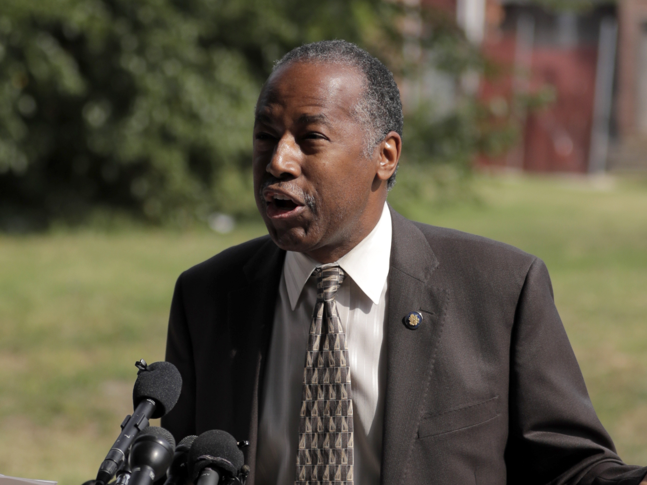 caption: HUD Secretary Ben Carson speaks during a news conference after touring a housing development in Baltimore. Carson: "There are problems and we can't sweep them under the rug."