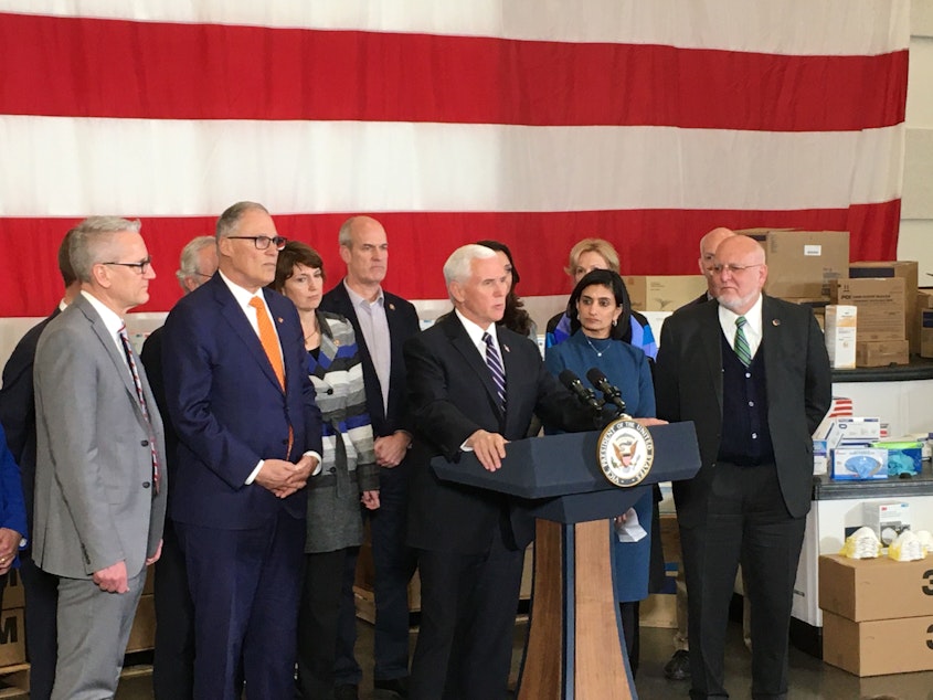 caption: Vice President Mike Pence, flanked by Gov. Jay Inslee, federal officials and members of the Congressional delegation during a visit to Washington on Thursday, March 5, 2020. 