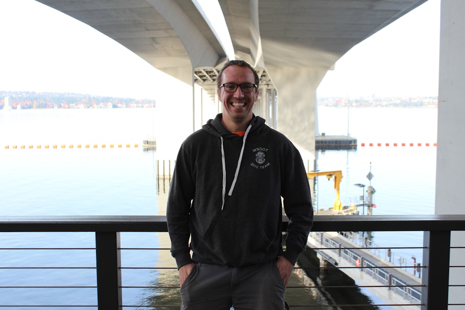caption: Loren Wilson, a bridge inspector for the Washington State Department of Transportation, stands beneath the SR 520 floating bridge. Wilson is both an engineer and a diver, so he does both above water and underwater inspections of bridges across the state.