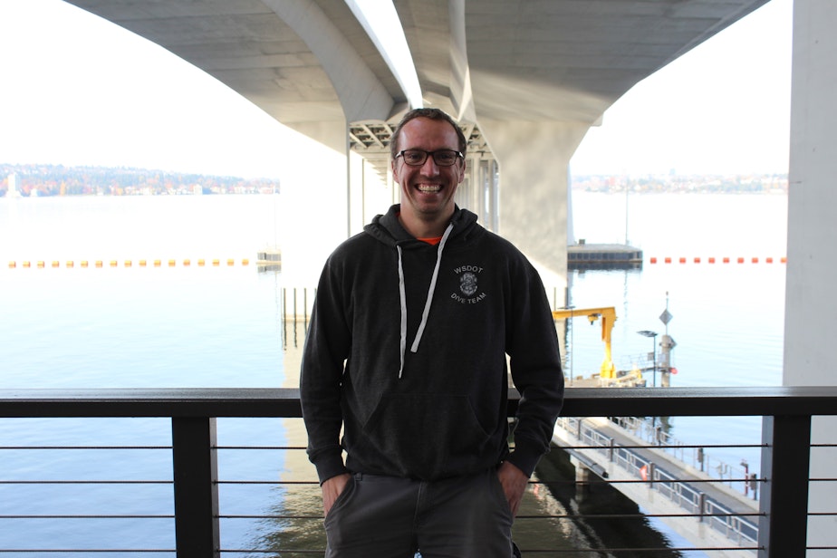 caption: Loren Wilson, a bridge inspector for the Washington State Department of Transportation, stands beneath the SR 520 floating bridge. Wilson is both an engineer and a diver, so he does both above water and underwater inspections of bridges across the state. 