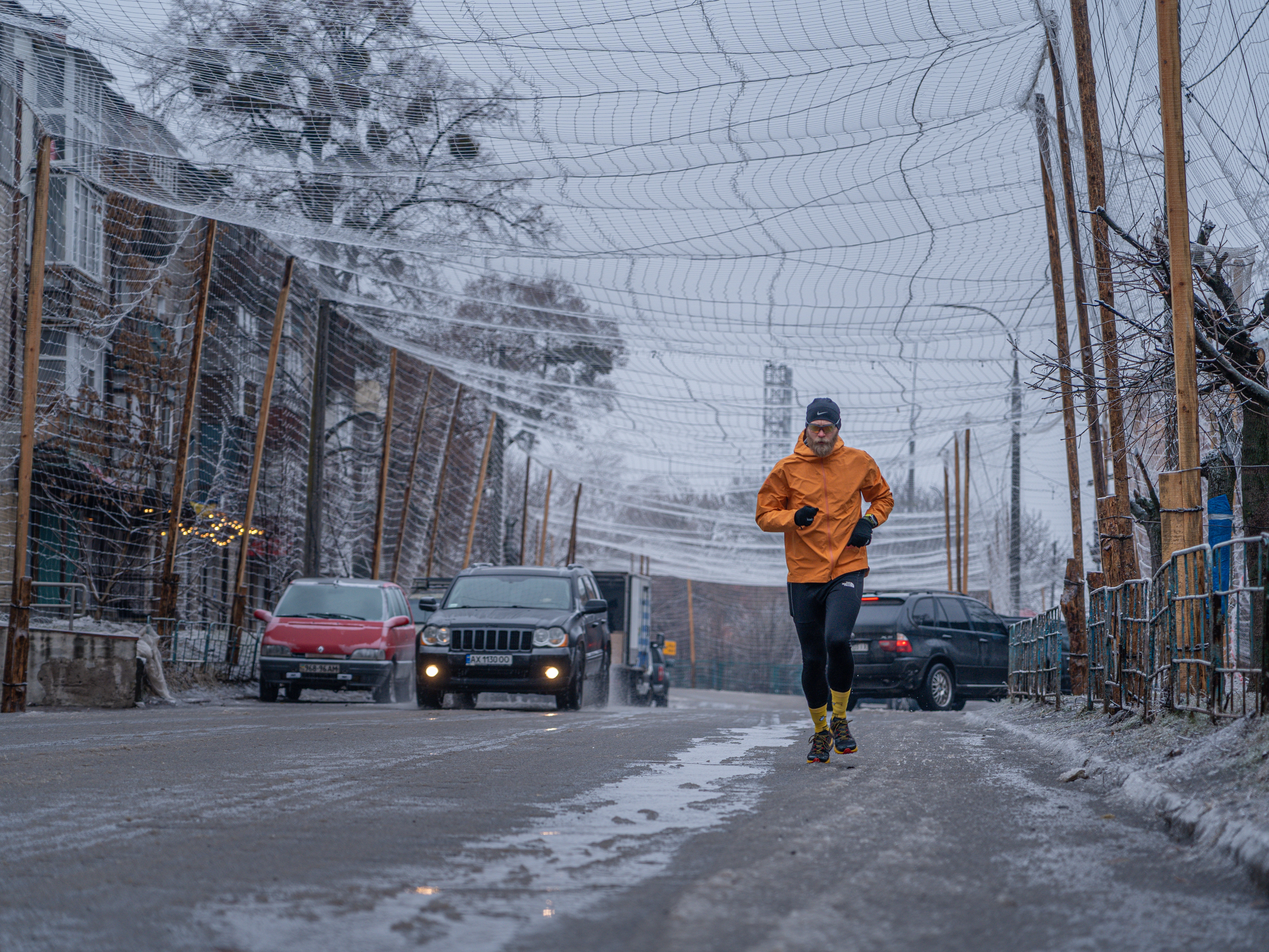 caption: Drone nets cover the streets of Izium, Ukraine, on Feb. 7. The netting discourages drones from diving at cars and people because their propellers get tangled in it.