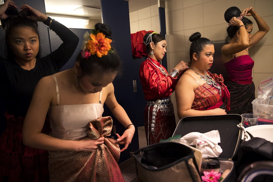 caption: Members of the Thai Dance Team get ready before performing during the Lunar New Year celebration on Sunday, Feb. 11, 2018, in the Chinatown-International District in Seattle.