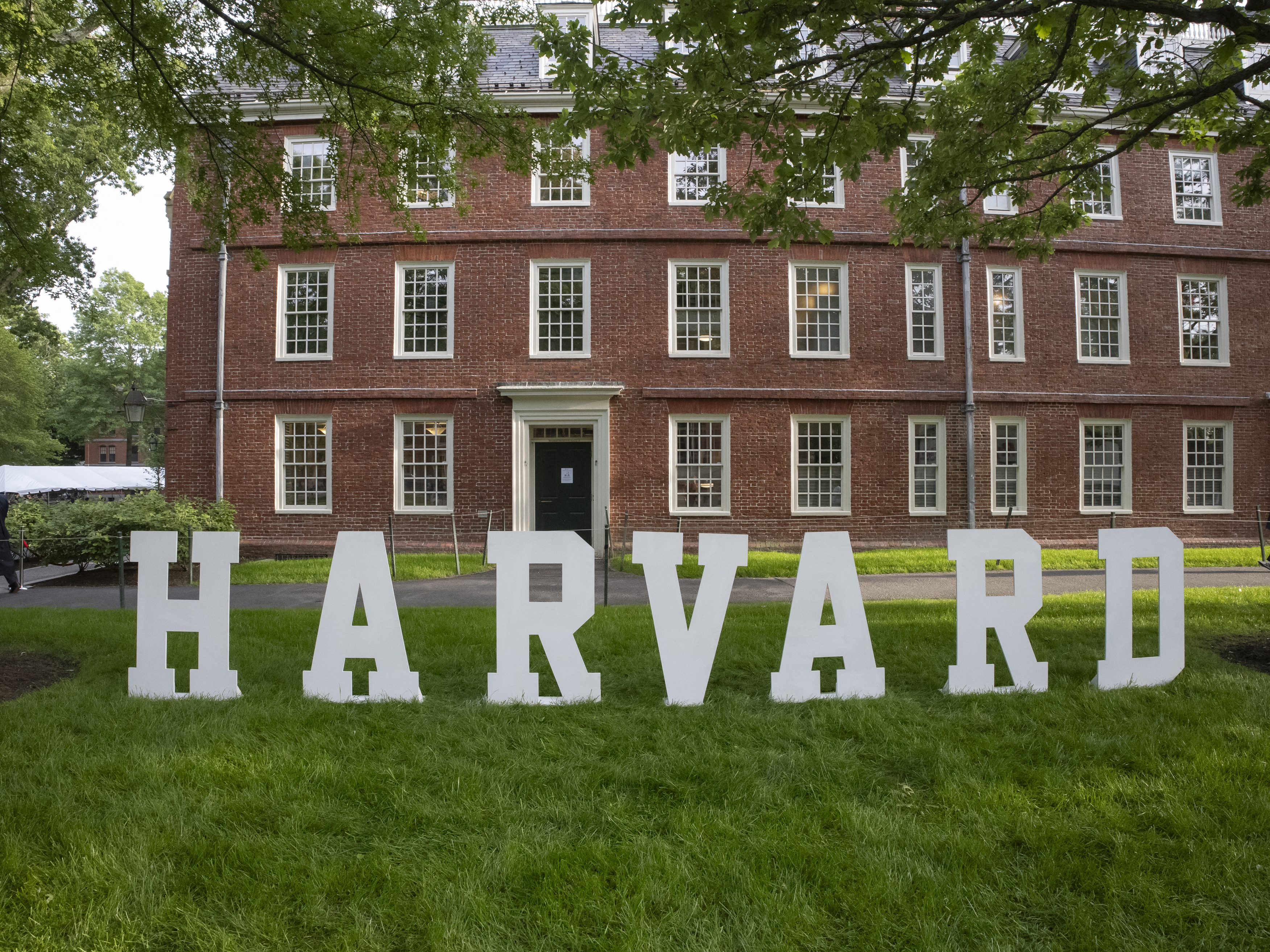 caption: A Harvard sign is seen at Harvard University's campus in May.