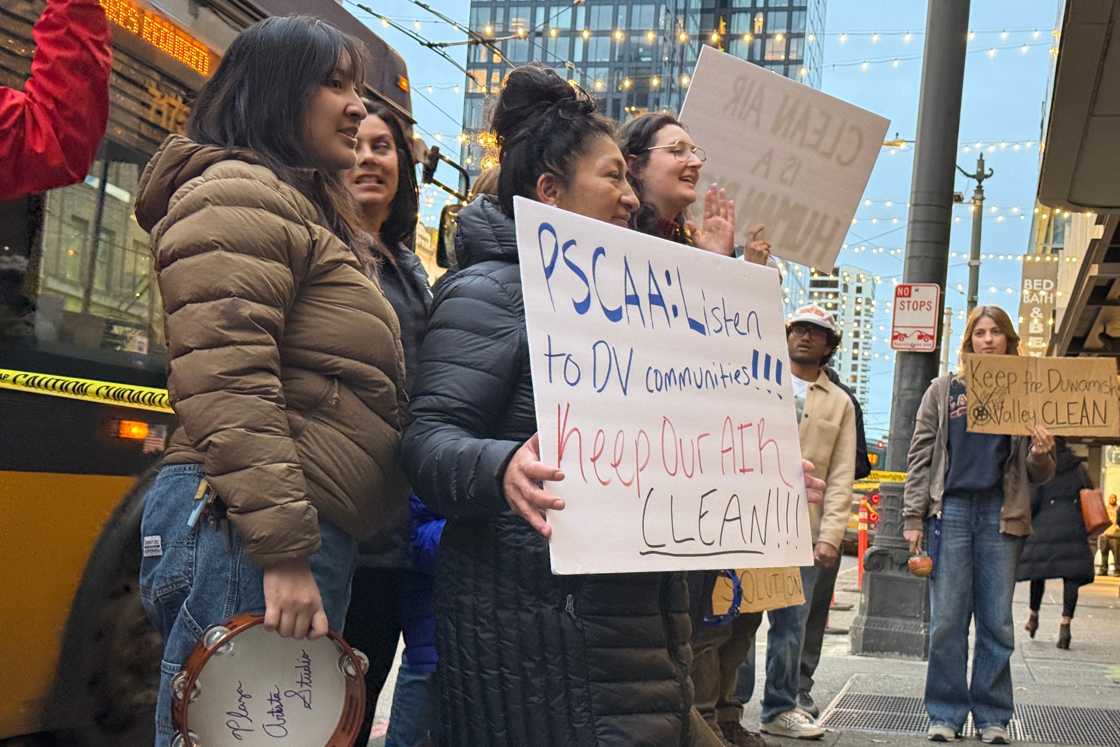 caption: Protesters rally against a cement plant's tire burning in Seattle on Nov. 21, 2025.