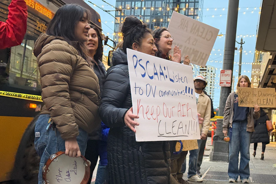 Caption: Protesters rally against a tire blaze at a cement factory in Seattle on November 21, 2025.