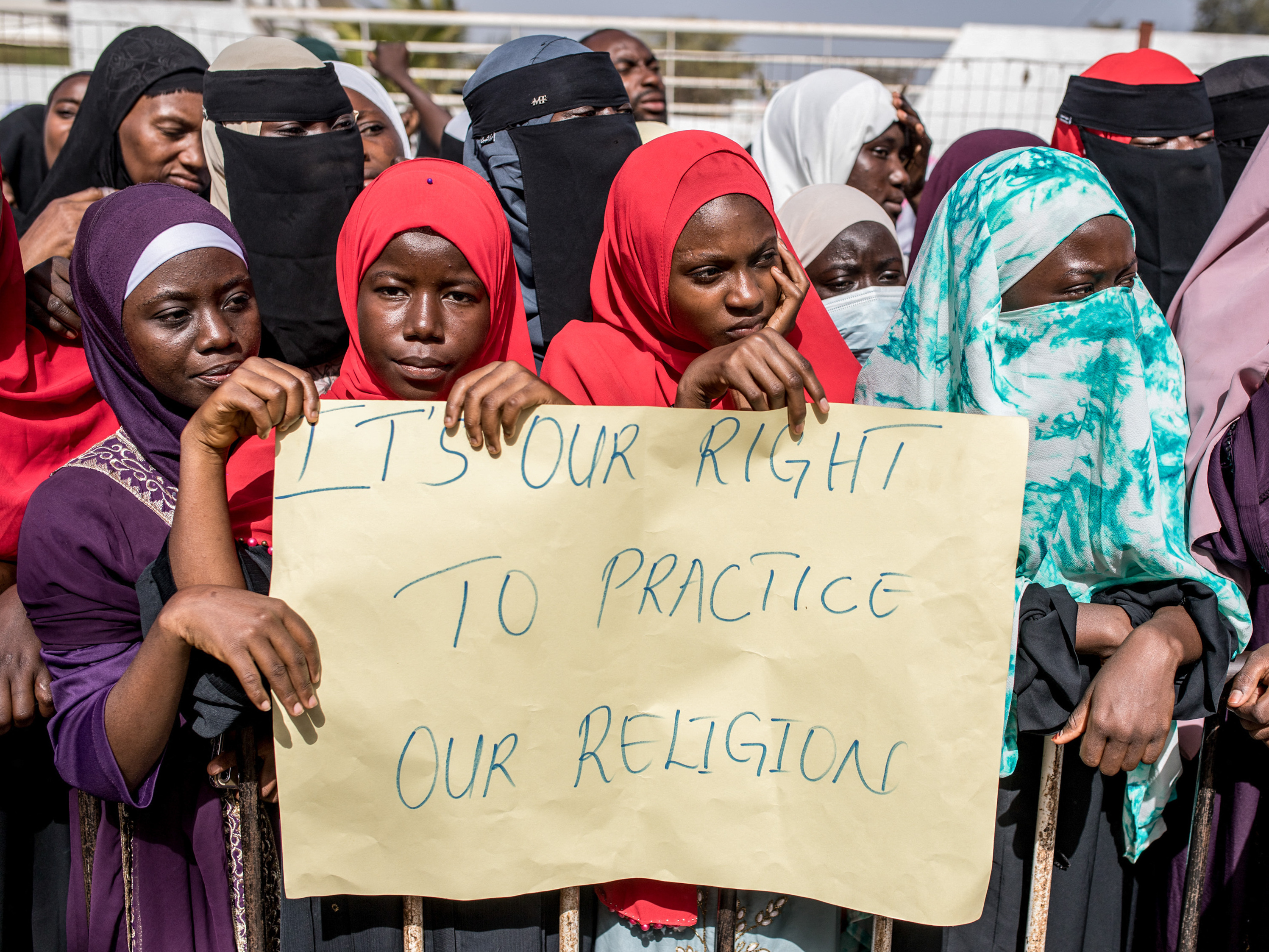 caption: Opponents of the ban on female genital mutilation (FGM) gather outside the National Assembly in Banjul, The Gambia, on March 18, 2024. Lawmakers voted to advance a highly controversial bill that would lift the ban on FGM.