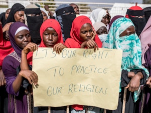 caption: Opponents of the ban on female genital mutilation (FGM) gather outside the National Assembly in Banjul, The Gambia, on March 18, 2024. Lawmakers voted to advance a highly controversial bill that would lift the ban on FGM.