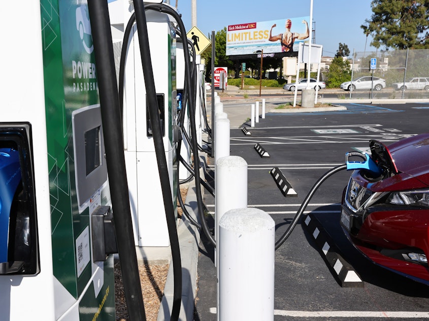 caption: A Nissan electric vehicle recharges at a Power Up fast charger station on April 14, 2022, in Pasadena, Calif. California has more chargers than any other state in the U.S., but the federal government is trying to expand charger access across the country.