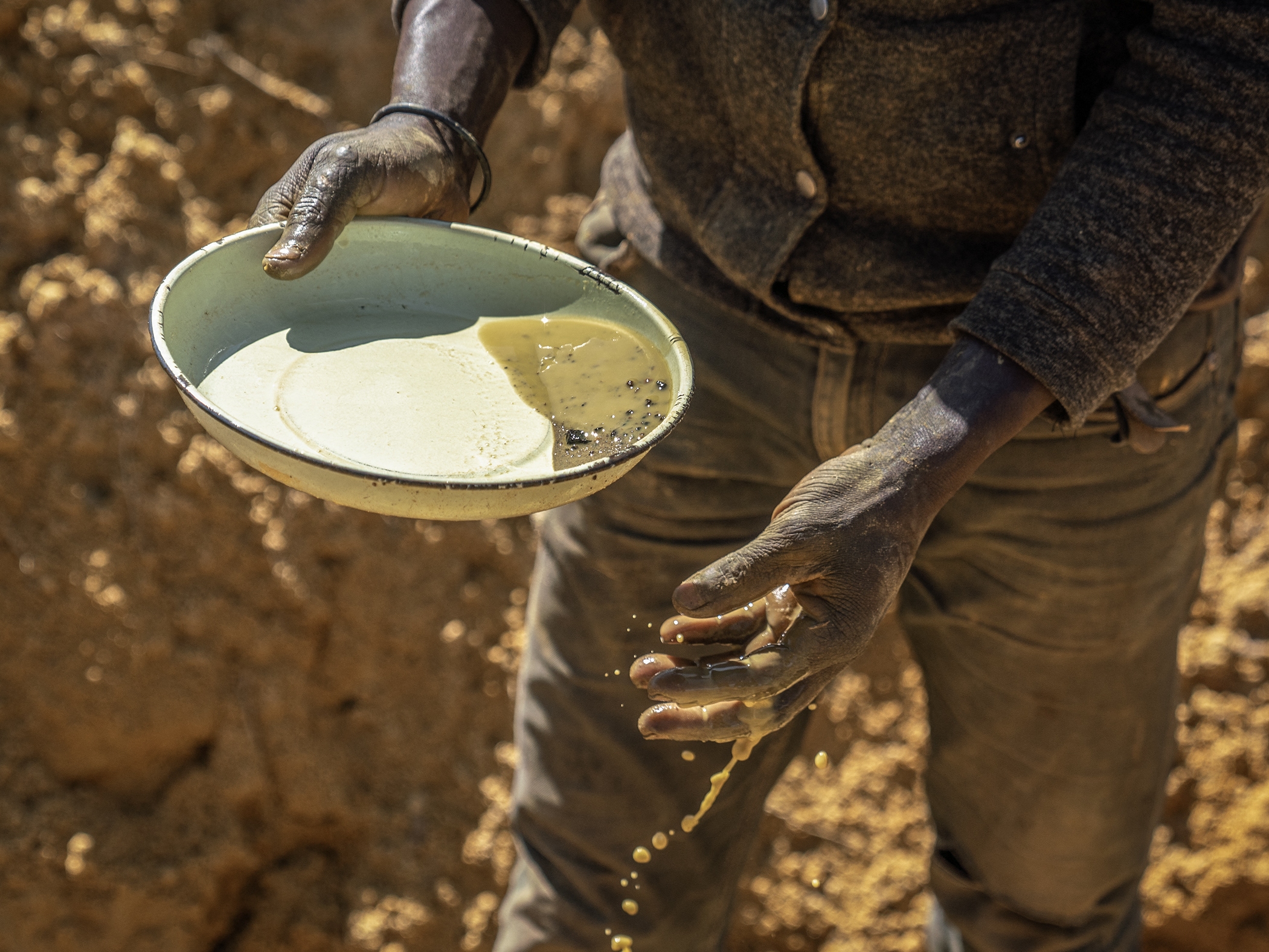 caption: An artisanal miner, locally known as a zama-zama, mines for gold at a mining operation in Stormhill, west of Johannesburg, on Aug. 11, 2023.
