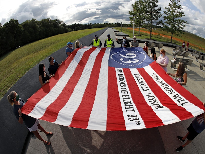 caption: Visitors to the Flight 93 National Memorial in Shanksville, Pa., participate in a memorial service Thursday ahead of the 19th anniversary of the Sept. 11 attacks.