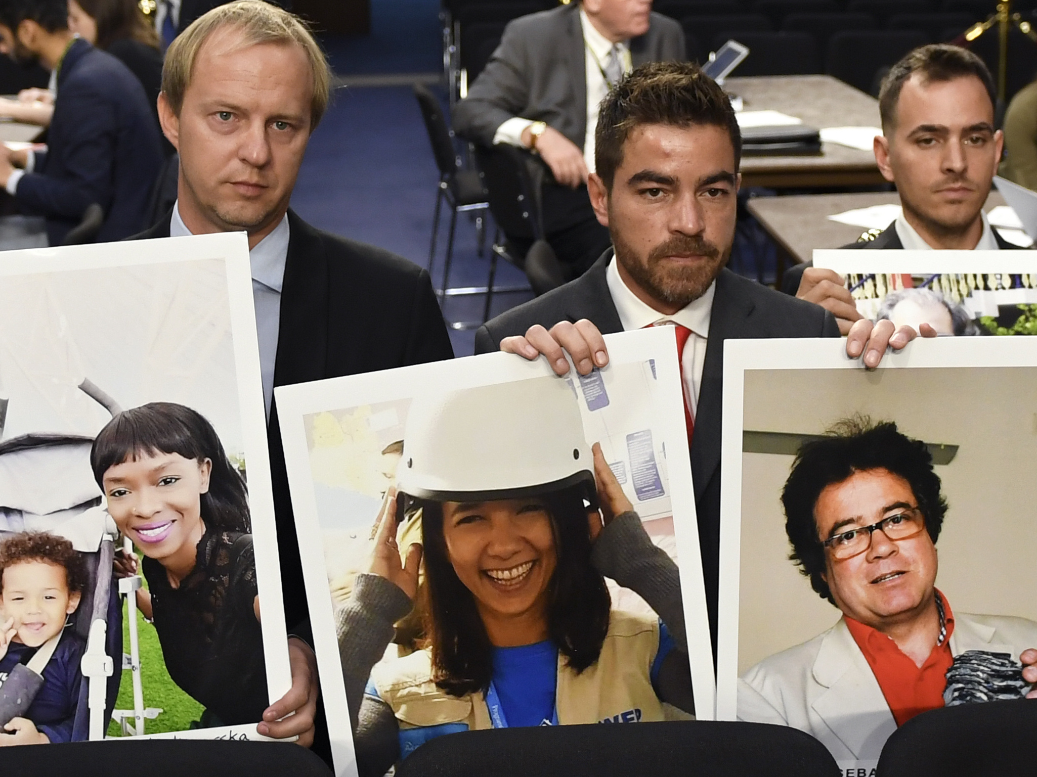 caption: Family members hold photos of victims killed on Ethiopian Airlines Flight 302 and Lion Air Flight 610 on Tuesday.