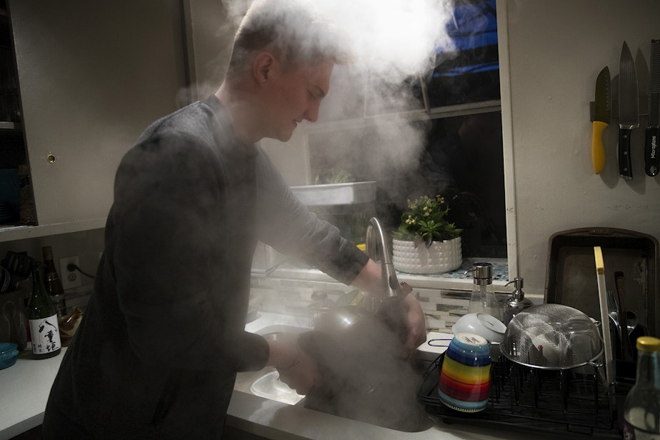 caption: Biggest carbon loser contestant Will Wilson cooks ramen at his apartment on Monday, February 10, 2020, in Seattle. 