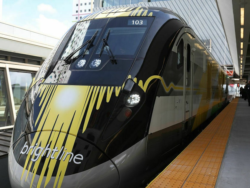 caption: A Brightline train during its inaugural trip between Miami and West Palm Beach, Fla., in 2018. This week, the White House announced $3 billion in funding for Brightline West, a proposed high-speed rail line connecting Las Vegas and Southern California.