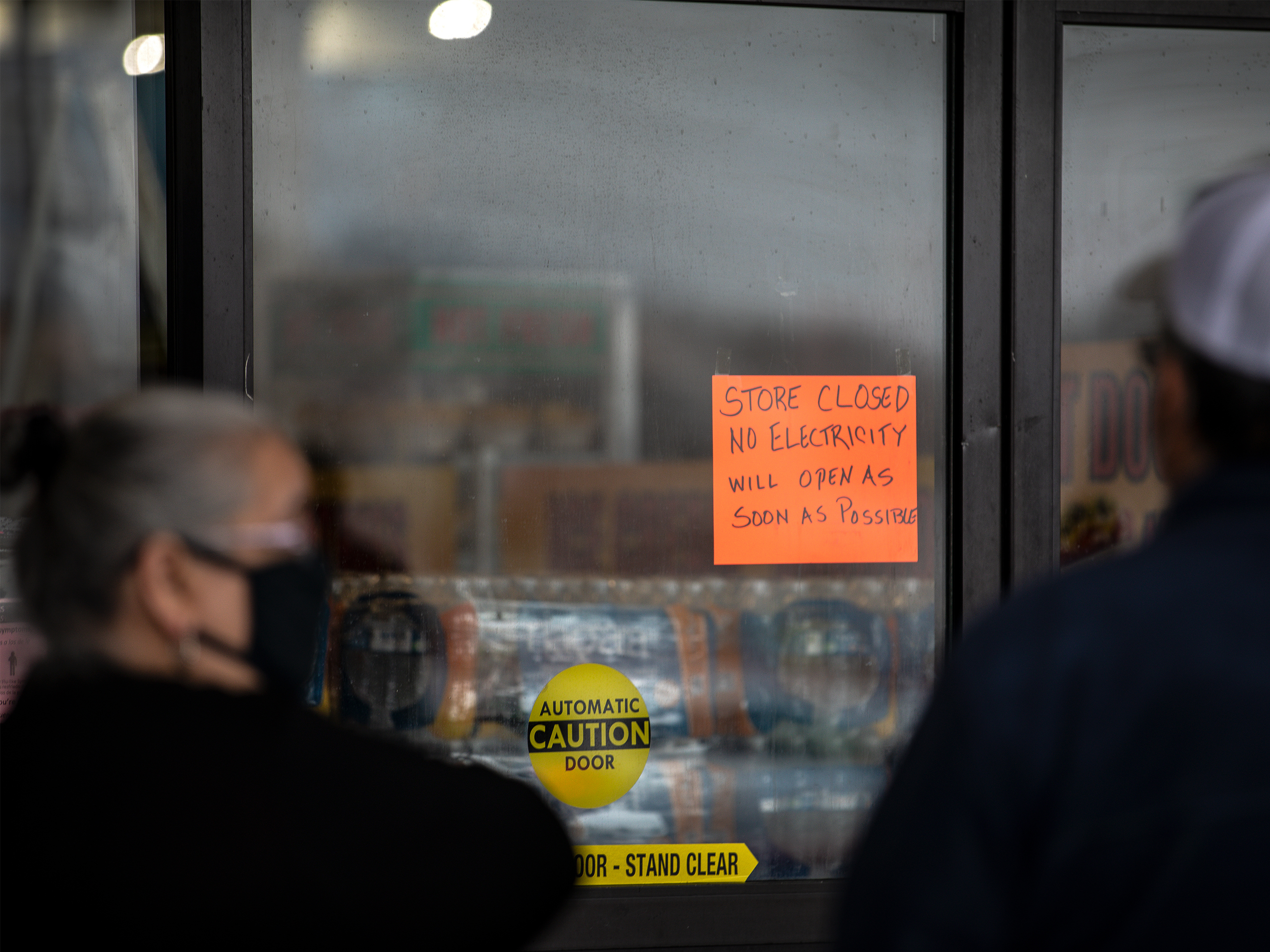 caption: People wait in line for Fiesta Mart to open after the store lost electricity in Austin, Texas on February 17, 2021.