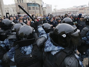 caption: Demonstrators in Moscow clash with police Sunday during a protest against the jailing of Alexei Navalny. Thousands of people took to the streets across Russia to demand the opposition leader's release.