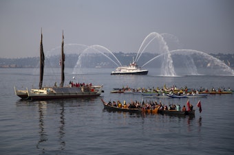 caption: Suquamish, Muckleshoot and Hawaiian canoes surround  Polynesian canoe Hokule'a during a water welcome ceremony on Elliot Bay on Saturday, August 26, 2023, in Seattle. 