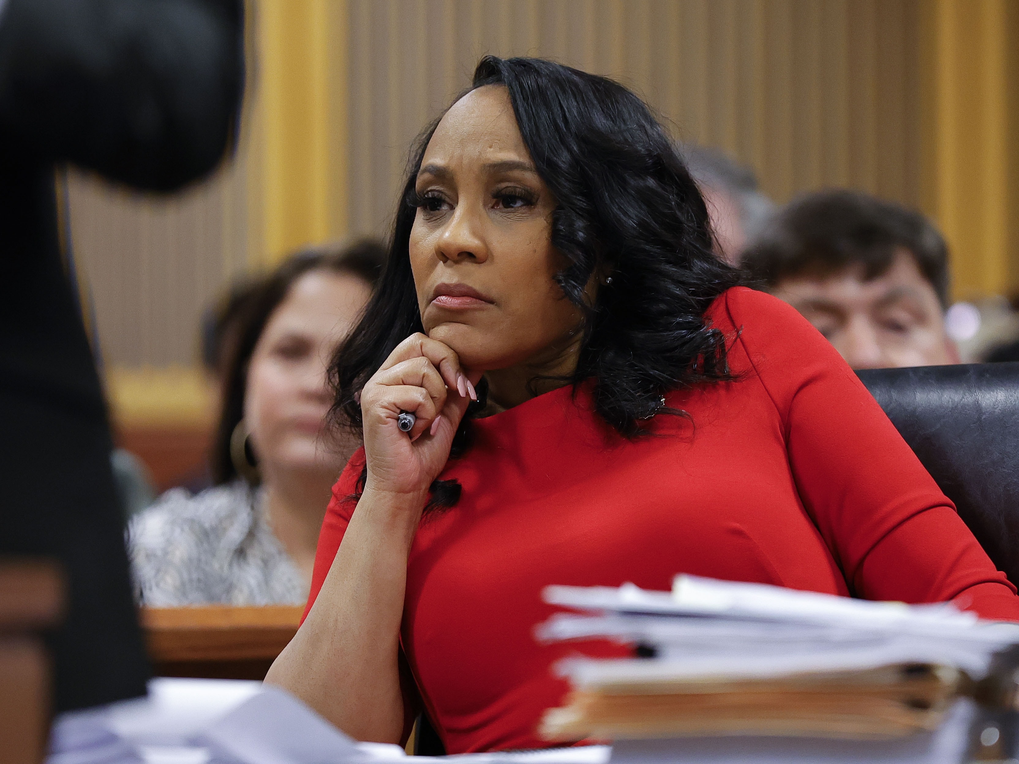 caption: Fulton County District Attorney Fani Willis looks on during a hearing in the Georgia election interference case on March 1 in Atlanta.