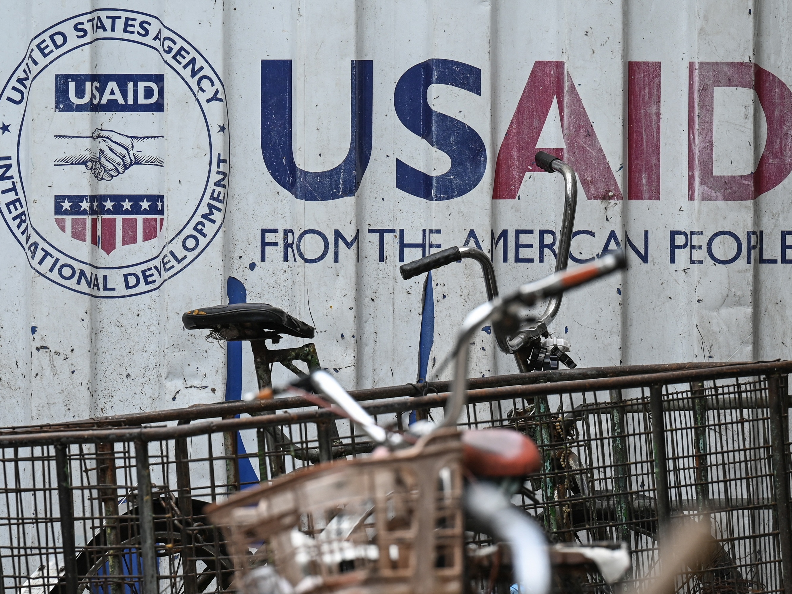 caption: A cargo container in Manila bears signage for the U.S. government's humanitarian agency USAID. The Trump administration suspended most USAID projects; a judge is now calling for the freeze to be lifted.