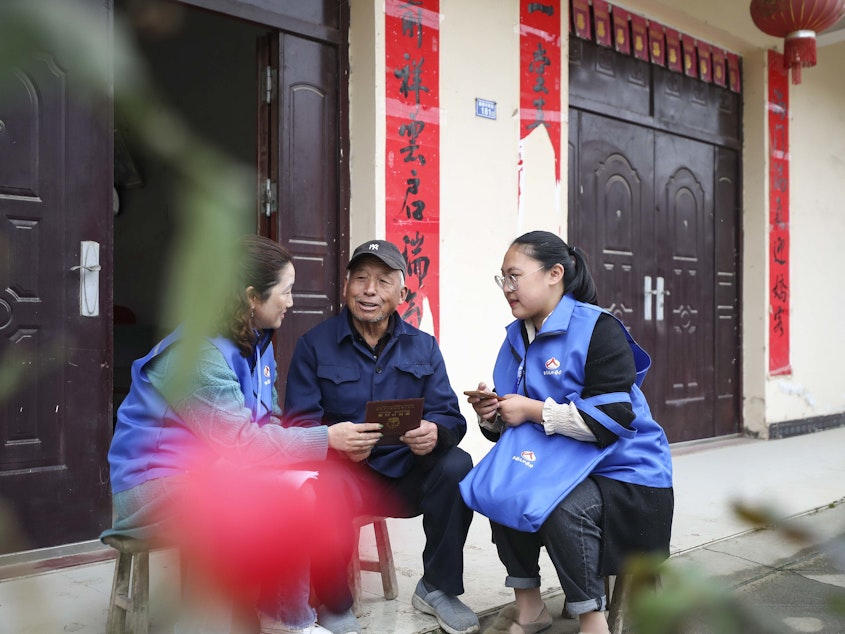 caption: Workers in China collect demographic data in the the seventh population census on Nov. 1, 2020.