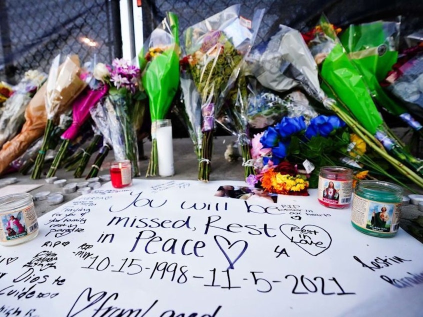caption: Candles, flowers and letters were placed at a memorial outside of the canceled Astroworld music festival at NRG Park on Sunday in Houston.
