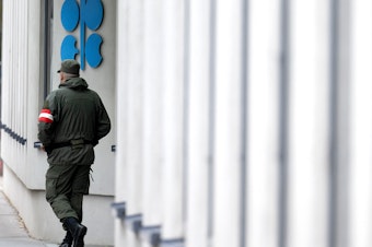 caption: An Austrian soldier guards the entrance of the OPEC headquarters in Vienna on October 4, on the eve of the 45th Meeting of the Joint Ministerial Monitoring Committee and the 33rd OPEC and non-OPEC Ministerial Meeting. OPEC and its allies agreed to reduce their production quotas at that meeting.