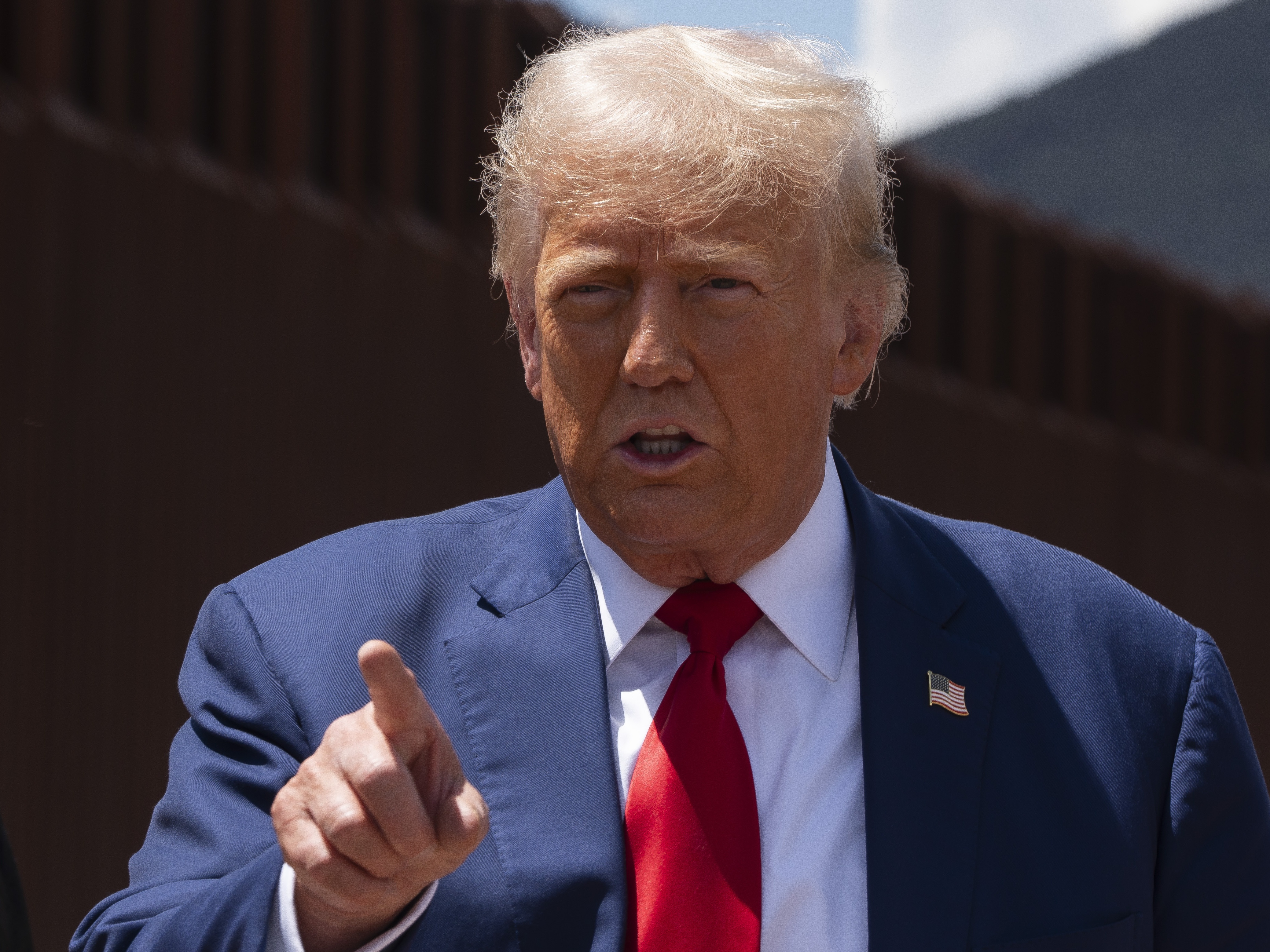 caption: Former President Donald Trump speaks at the U.S.-Mexico border Thursday near Sierra Vista, Ariz. 