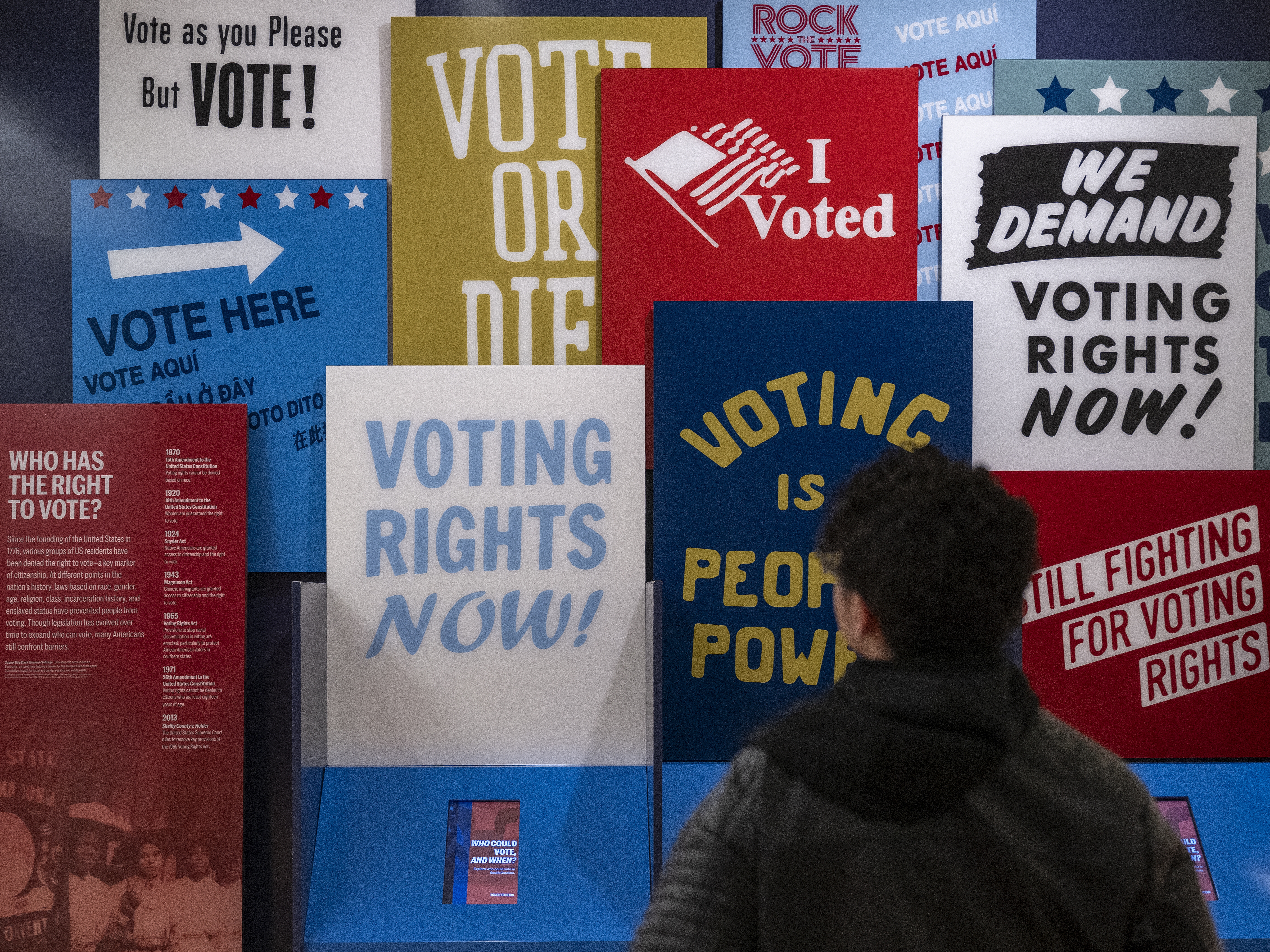 caption: A visitor looks at an exhibition on voting rights in the U.S. at the International African American Museum in Charleston, S.C., in January.