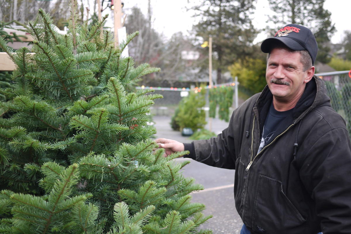 caption: Former Seattle resident, Barry Ford, sells Christmas trees in the Central District.