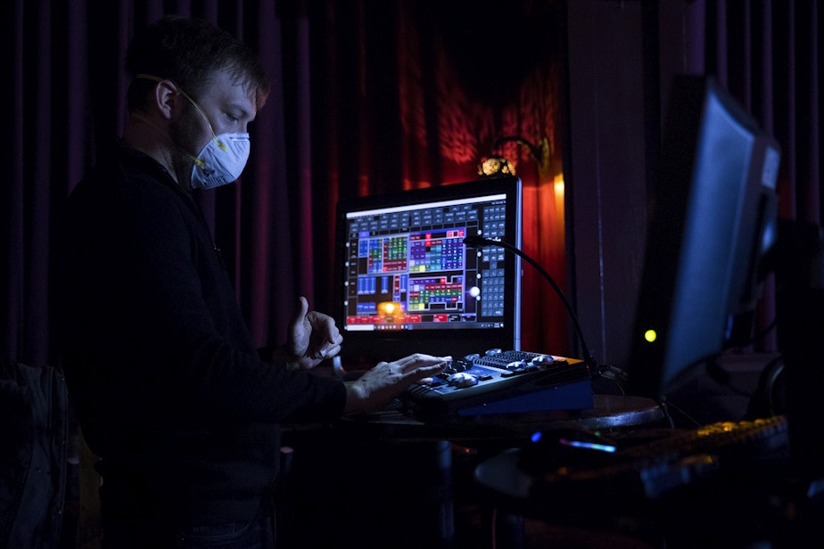 caption: Technical Director Michael Rotchadl wears a mask while working during a live-streamed Le Faux happy hour show on Wednesday, May 20, 2020, at Julia's on Broadway in Seattle. 